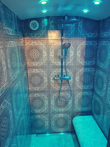 a shower in a room with a tiled wall at Stodingerhütte in Winkl