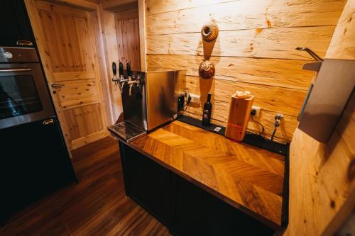 a kitchen with a counter with wooden walls at Stodingerhütte in Winkl