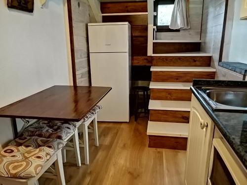 a kitchen with a table and a refrigerator at La Fragua del Canajal apartamentos in San Cosme