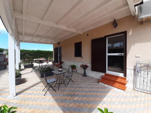 a patio with chairs and a table on a house at Laura in Vieste