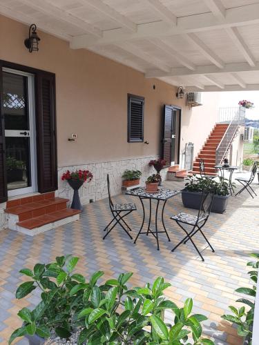 a patio with chairs and a table and stairs at Laura in Vieste
