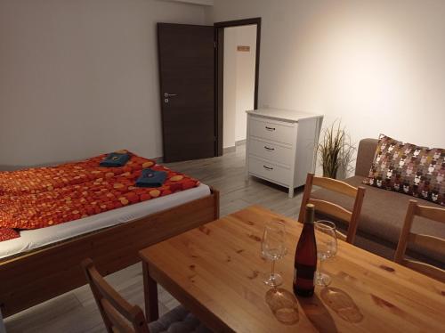 a bedroom with a bed and a table with wine glasses on it at Tiptop Apartment & Outdoor Activities in Bovec