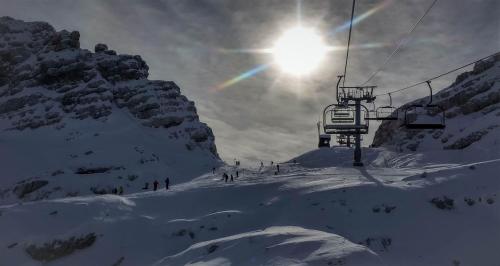 a group of people on a ski lift in the snow at Hiša Bohinc z wellnessom in Tolmin