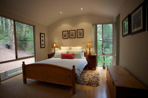 a bedroom with a bed and a large window at Honeymoon View in Denmark