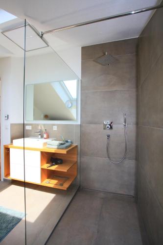 a bathroom with a sink and a shower at See-Flair in Immenstaad am Bodensee