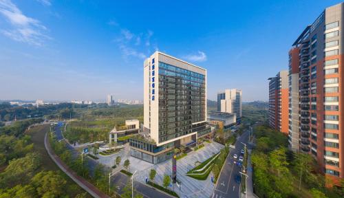an aerial view of a tall building in a city at Novotel Dongguan Songshan in Dongguan
