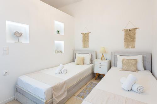 ハニア・タウンにあるErofili Ηouseの白い壁のベッドルーム1室(ベッド2台付)
