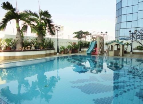 a swimming pool with a slide in a hotel at United Tower Thonglor by Aspira in Bangkok