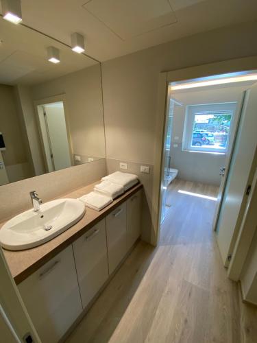 a bathroom with a sink and a mirror at Chaligne Suite in Aosta