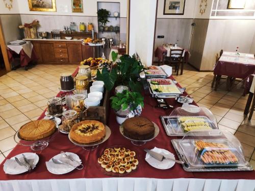a table with many different types of food on it at Hotel Carignano in Lucca