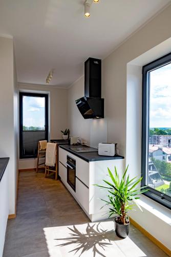 a kitchen with a counter and a large window at Artisa Riia Str 20B Luxury Penthouse apartment in Tartu
