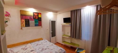 a small bedroom with a bed and a window at Sentosa ROOM in Nesebar