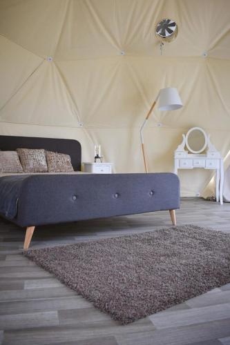 a bedroom with a bed in a tent at Glempings Velo Latgale in Izvalta