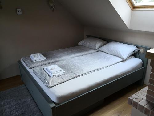 a bed in a room with two towels on it at House Bovecation in Bovec