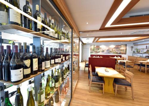 a wine tasting room with bottles of wine on shelves at Hotel Restaurant Fallerhof in Bad Krozingen