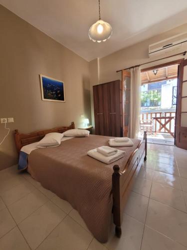a bedroom with a large bed with two towels on it at Irida Studios in Agios Ioannis Pelio