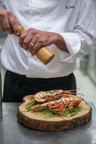 a chef is preparing food on a cutting board at La Sultana Oualidia in Oualidia