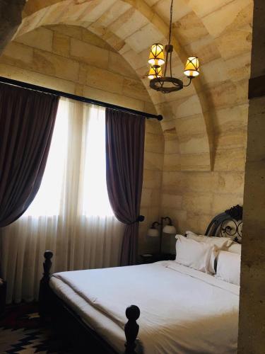 Ένα ή περισσότερα κρεβάτια σε δωμάτιο στο Exedra Cappadocia