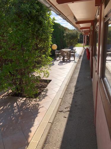 a sidewalk next to a building with a table at Hotel Cristol in Avignon