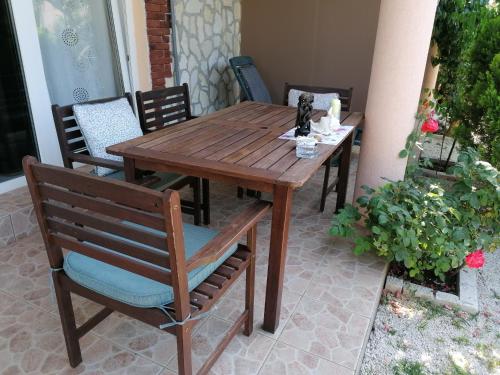 een houten tafel en stoelen op een patio bij Apartman Rafael in Medulin