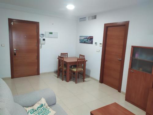 a living room with a table and a tv at Apartamento en Águilas in Águilas