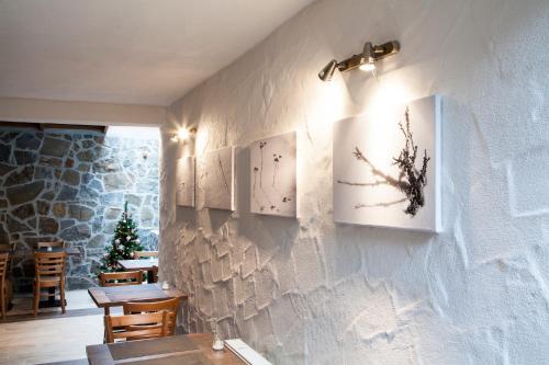 a restaurant with a wall with two pictures on it at Penzion Snezienka in Tatranská Lomnica