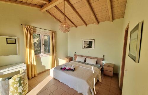 a bedroom with a bed with flowers on it at Villa Nautique - Waterfront in Sivota
