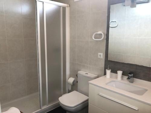 a bathroom with a shower and a toilet and a sink at La Sirena in Les tres Cales