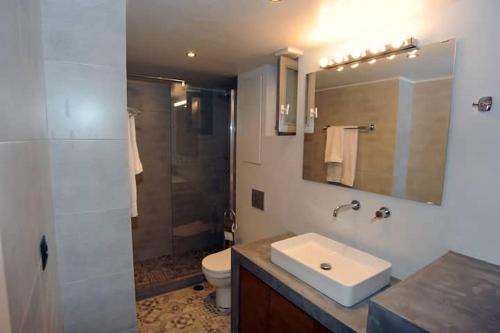 a bathroom with a sink and a toilet and a shower at CRECIAN WATER FRONT in Egira