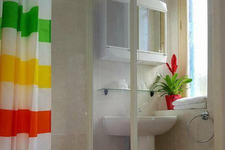 a bathroom with a sink and a colorful wall at Hôtel**résidence BEAR in Port-Vendres