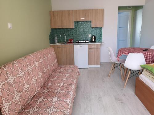 a living room with a couch and a kitchen at Róża Wiatrów 2 Władysławowo in Władysławowo