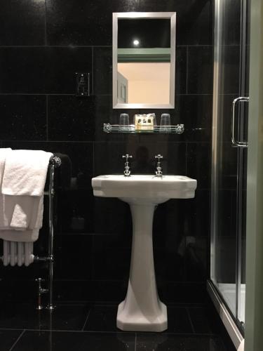 a bathroom with a sink and a mirror at The Wrea Head Hall Country House Hotel & Restaurant in Scarborough