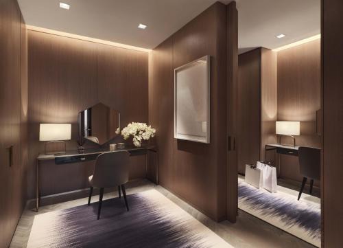 a hotel room with a desk and a mirror at Four Seasons Hotel Kuwait at Burj Alshaya in Kuwait
