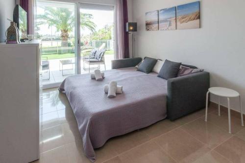 a bedroom with a large bed with two candles on it at Paradise - Oliva Nova playa MET&GOLF in Oliva