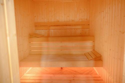 a sauna with wooden shelves and a wooden floor at Вила Влахов in Sapareva Banya