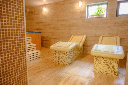 two wicker chairs and a table in a room at Вила Влахов in Sapareva Banya