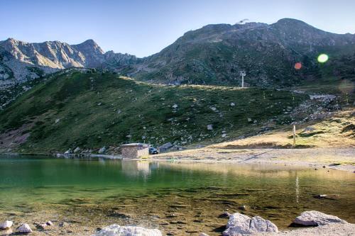 a view of a mountain with a body of water at Hotel Terranova in Pas de la Casa