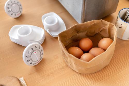 a bag of eggs on a table next to a scale at Panoramahotel Stocker in Pruggern