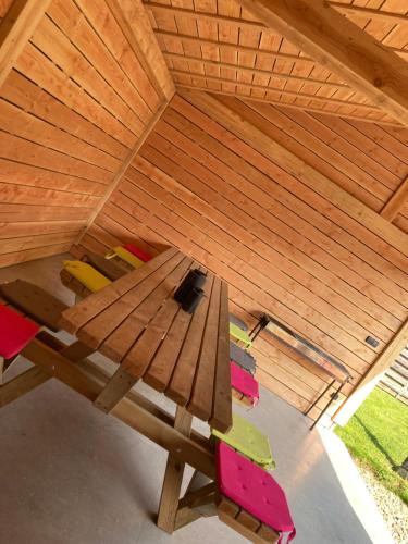 a wooden table with chairs in a wooden ceiling at Ferienhof A&B Wellness Villa 12 personen in Bullange
