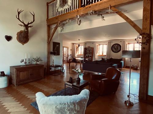 a living room with a couch and a table at Domaine de Cazal - Chambres d'Hôtes avec piscine au cœur de 26 hectares de nature préservée in Saint-Cyprien