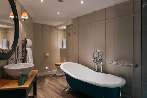 a bathroom with a tub and a sink at Greenbank Hotel in Falmouth