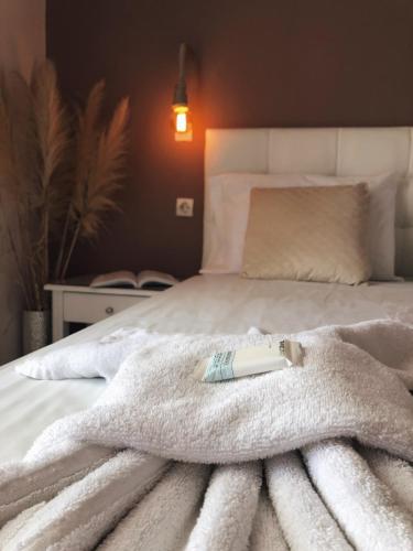 a white blanket laying on top of a bed at Andy’s apartments in Georgioupolis