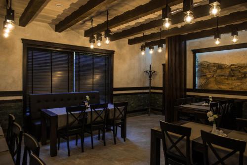 a dining room with tables and chairs and lights at Chalet Carpat Dream in Synevyr