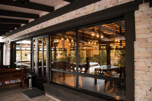 a restaurant with large glass windows and a table at Chalet Carpat Dream in Synevyr