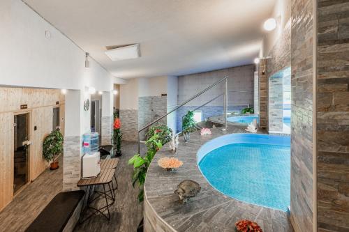 a large swimming pool in a house at Tíztó Vendégház in Baja