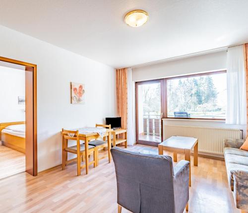 a living room with a couch and a table at Aparthotel Panorama in Bad Soden-Salmünster
