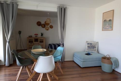- un salon avec une table, des chaises et un canapé dans l'établissement Superb Apartment Near The Sea, à Arcachon