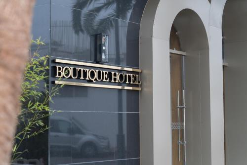 a sign for a boutique hotel on the side of a building at Imperial Boutique Hotel Rabat in Rabat