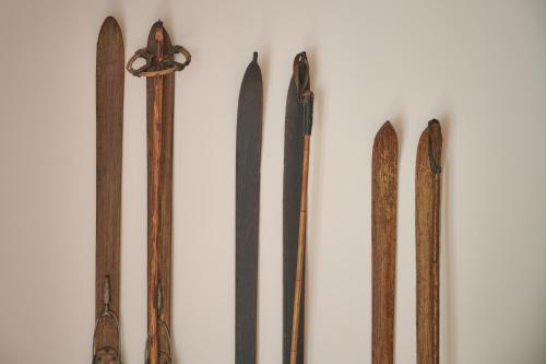 a group of different types of wooden weapons on a wall at Triangel Boutique Hotel in Kranjska Gora