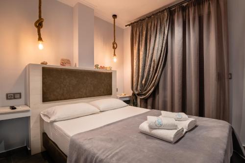 a bedroom with a bed with towels on it at Athena's Studios in Polykhrono